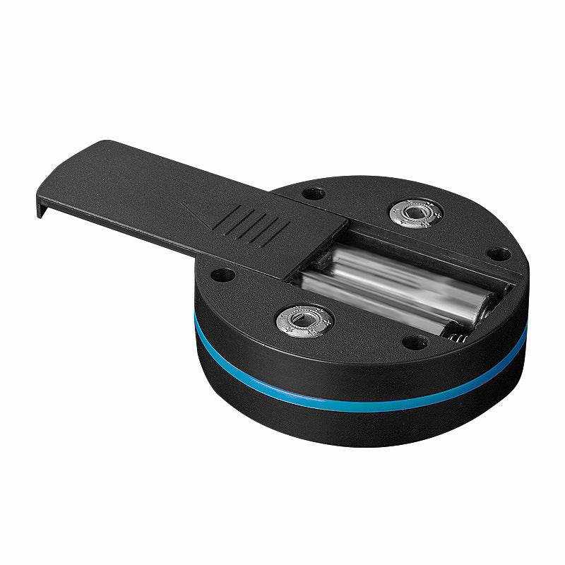 Compact black cervical massage paste device with battery compartment and blue accent ring