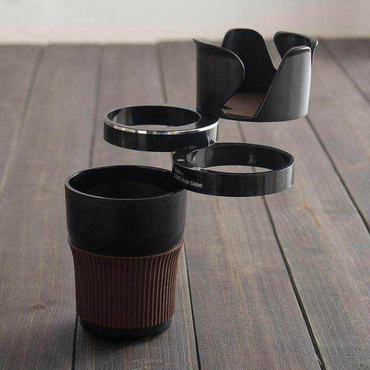 Black ABS car cup holder with rubber sleeve and rotating multi-ring design for drinks and small items storage