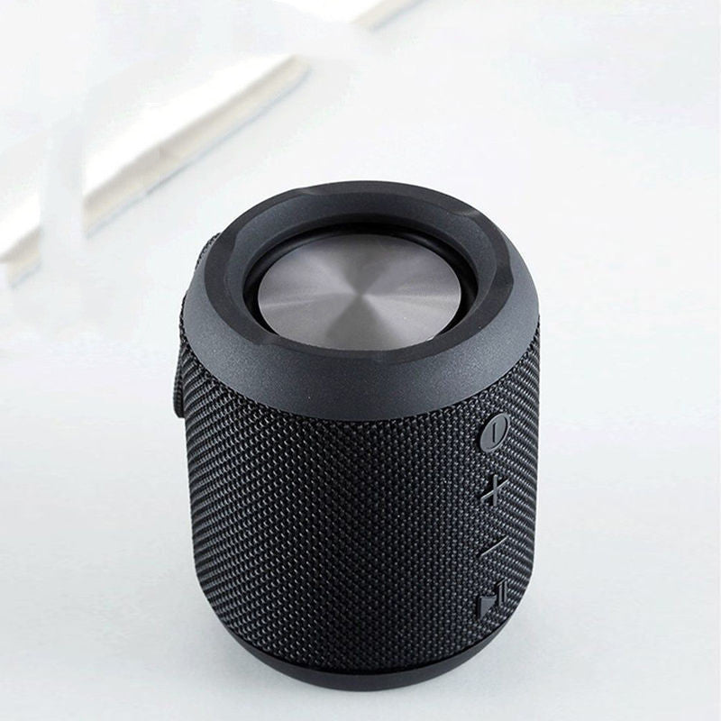 Black textured Bluetooth speaker on a white background