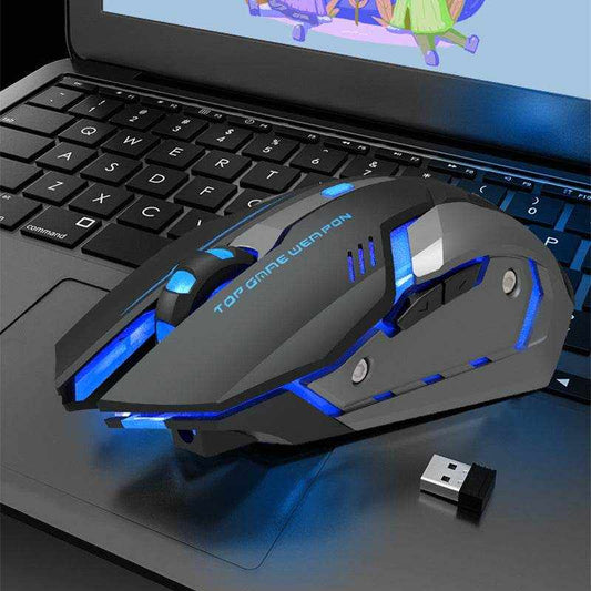 Wireless charging silent gaming mouse with ergonomic design and blue LED lights on laptop keyboard.